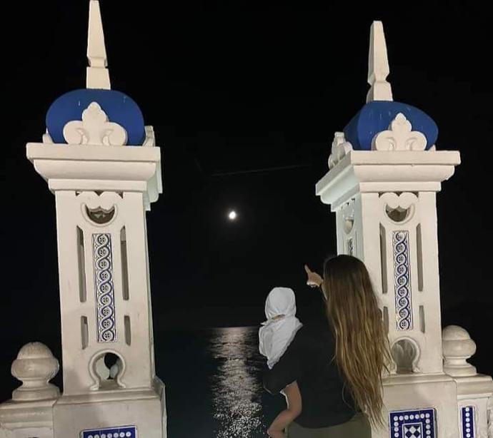 mujer señalando a la luna